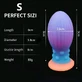Kleine siliconen eivormige buttplug die in het donker oplicht, met zuignap, 9 x 3,8 cm - veelkleurig